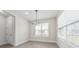 Dining room with a modern chandelier and large windows, offering plenty of natural light at 13181 Telsen St # 39, Winter Garden, FL 34787