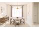 Bright dining room with a stylish light fixture, neutral decor, and large windows at 13181 Telsen St # 39, Winter Garden, FL 34787
