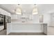 Modern kitchen featuring white cabinets, quartz countertops, and stainless steel appliances with large island at 13181 Telsen St # 39, Winter Garden, FL 34787
