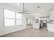 Open-concept kitchen with a large island, stainless steel appliances, and bright natural lighting at 13181 Telsen St # 39, Winter Garden, FL 34787