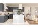Contemporary kitchen with dark cabinetry, a large island, and open layout to the living space at 13181 Telsen St # 39, Winter Garden, FL 34787