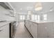 Spacious kitchen with stainless steel appliances, quartz countertops, a large island, and natural lighting at 13181 Telsen St # 39, Winter Garden, FL 34787