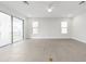 Open and airy living room with a large sliding glass door and tile floors at 13181 Telsen St # 39, Winter Garden, FL 34787