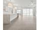 Bright living room with tile flooring, recessed lighting, fan, quartz countertops, island and sliding glass doors at 13181 Telsen St # 39, Winter Garden, FL 34787