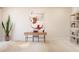 Bright office space with a wooden desk, artwork, snake plant, and shelving unit at 13181 Telsen St # 39, Winter Garden, FL 34787