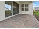 Covered patio features brick pavers, sliding glass doors, and a view of the backyard at 13181 Telsen St # 39, Winter Garden, FL 34787