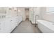Bright bathroom features dual vanities, a soaking tub, and a separate glass-enclosed shower at 13187 Telsen St # 38, Winter Garden, FL 34787