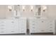 Bathroom with double sink vanity featuring white cabinetry, modern mirrors and wall lighting at 13187 Telsen St # 38, Winter Garden, FL 34787