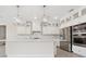 Bright, open kitchen featuring white cabinets, stainless steel appliances, and a large center island at 13187 Telsen St # 38, Winter Garden, FL 34787