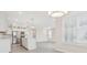 Elegant kitchen featuring stainless steel appliances, white cabinets with glass fronts, and an island overlooking the dining area at 13187 Telsen St # 38, Winter Garden, FL 34787