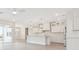 Open concept kitchen with white cabinetry, a large island, and stainless steel appliances at 13187 Telsen St # 38, Winter Garden, FL 34787