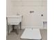 Bright laundry room features a utility sink and overhead shelving for storage convenience at 13187 Telsen St # 38, Winter Garden, FL 34787