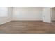 Spacious room with hardwood flooring and paneling details along the wall at 13187 Telsen St # 38, Winter Garden, FL 34787