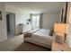 Bright bedroom featuring neutral decor, plush carpeting, and a sunlit window view at 14533 Crestavista Ave, Clermont, FL 34714