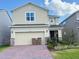Charming two-story home with brick driveway, two-car garage, and well-maintained landscaping at 14533 Crestavista Ave, Clermont, FL 34714
