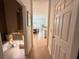 Hallway with hardwood floors, view into dining and kitchen, and a half bath at 14533 Crestavista Ave, Clermont, FL 34714