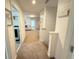 Upstairs hallway with carpeted floor, view into the living room, and decor sign on the wall at 14533 Crestavista Ave, Clermont, FL 34714