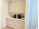 Butler's pantry with matching cabinetry, countertop space, and under cabinet lighting at 14533 Crestavista Ave, Clermont, FL 34714