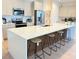 Modern kitchen features stainless steel appliances and a large island with countertop seating at 14533 Crestavista Ave, Clermont, FL 34714