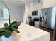 Close up of kitchen island featuring stainless steel appliances and modern cabinetry at 14533 Crestavista Ave, Clermont, FL 34714