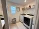 Functional laundry room with modern machines, decor, and window to bring in natural light at 14533 Crestavista Ave, Clermont, FL 34714