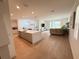 Open concept living area with wood floors, modern kitchen, and sliding glass doors at 14533 Crestavista Ave, Clermont, FL 34714