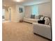 Carpeted living area featuring a comfortable sofa and an adjacent room at 14533 Crestavista Ave, Clermont, FL 34714