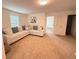 Spacious living room with plush carpeting and a comfortable sectional sofa at 14533 Crestavista Ave, Clermont, FL 34714
