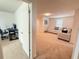 Second floor living room with plush carpeting leading to an adjacent room at 14533 Crestavista Ave, Clermont, FL 34714