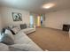 Upstairs, carpeted living room features a comfortable sectional and a hallway at 14533 Crestavista Ave, Clermont, FL 34714