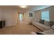 Upstairs living room with carpeting, a sofa, and connecting hallways at 14533 Crestavista Ave, Clermont, FL 34714