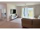 Bright living room with modern lighting, light colored walls, and sliding glass doors to the backyard at 14533 Crestavista Ave, Clermont, FL 34714