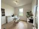 Bright home office with a glass-top desk, a window view, and ample storage at 14533 Crestavista Ave, Clermont, FL 34714