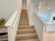 Staircase with wooden steps and white railings leading to the upper level at 14533 Crestavista Ave, Clermont, FL 34714
