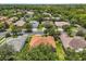 An aerial view of a single-Gathering home with mature landscaping and an established, leafy neighborhood at 187 Tall Pines Pass, Kissimmee, FL 34759