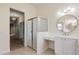 Modern bathroom featuring a glass-enclosed shower, white vanity, and stylish lighting fixtures at 187 Tall Pines Pass, Kissimmee, FL 34759