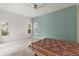 Light-filled bedroom with wood floors, white walls, and plantation shutters for ample natural light at 187 Tall Pines Pass, Kissimmee, FL 34759