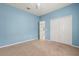 Spacious bedroom with blue walls and carpet, featuring a closet and a ceiling fan at 187 Tall Pines Pass, Kissimmee, FL 34759