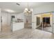 Open concept living area flowing into kitchen, with access to a screened patio at 187 Tall Pines Pass, Kissimmee, FL 34759