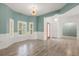 Living room showcasing natural light, wainscoting, and stylish lighting fixture at 187 Tall Pines Pass, Kissimmee, FL 34759