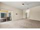 Bright living room featuring a ceiling fan, neutral carpet, and sliding glass doors to an outdoor patio at 187 Tall Pines Pass, Kissimmee, FL 34759