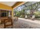 Spacious screened-in patio with brick flooring and outdoor furniture, perfect for entertaining guests at 187 Tall Pines Pass, Kissimmee, FL 34759