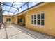 Covered patio with brick flooring, offering a relaxing outdoor living space with views of the yard at 187 Tall Pines Pass, Kissimmee, FL 34759