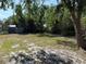 View of the spacious backyard, with mature trees and a fence, creating a private outdoor space at 1931 N Portillo Dr, Deltona, FL 32738