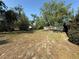 Backyard featuring a large grassy area with mature trees on a sunny day at 1931 N Portillo Dr, Deltona, FL 32738