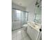 A bathroom with a shower stall with a sliding glass door and a vanity with a sink at 1931 N Portillo Dr, Deltona, FL 32738