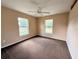 A bedroom features neutral paint, carpet, and two windows at 1931 N Portillo Dr, Deltona, FL 32738