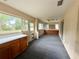 The enclosed porch features built-in cabinets, ceiling fan, and several windows for natural light at 1931 N Portillo Dr, Deltona, FL 32738