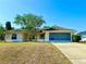 Charming single-story home featuring a well-maintained lawn, driveway, and two car garage at 1931 N Portillo Dr, Deltona, FL 32738