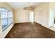 Spacious living room with large windows, neutral paint, carpeted floors, and arched doorway at 1931 N Portillo Dr, Deltona, FL 32738